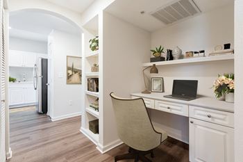 a home office with a desk and a chair